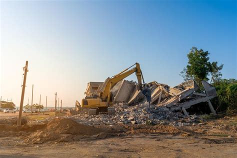 guy destroys building with mini excavator|Construction worker destroys hotel lobby with heavy equipment.